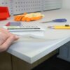 a hand holding a cutting mat