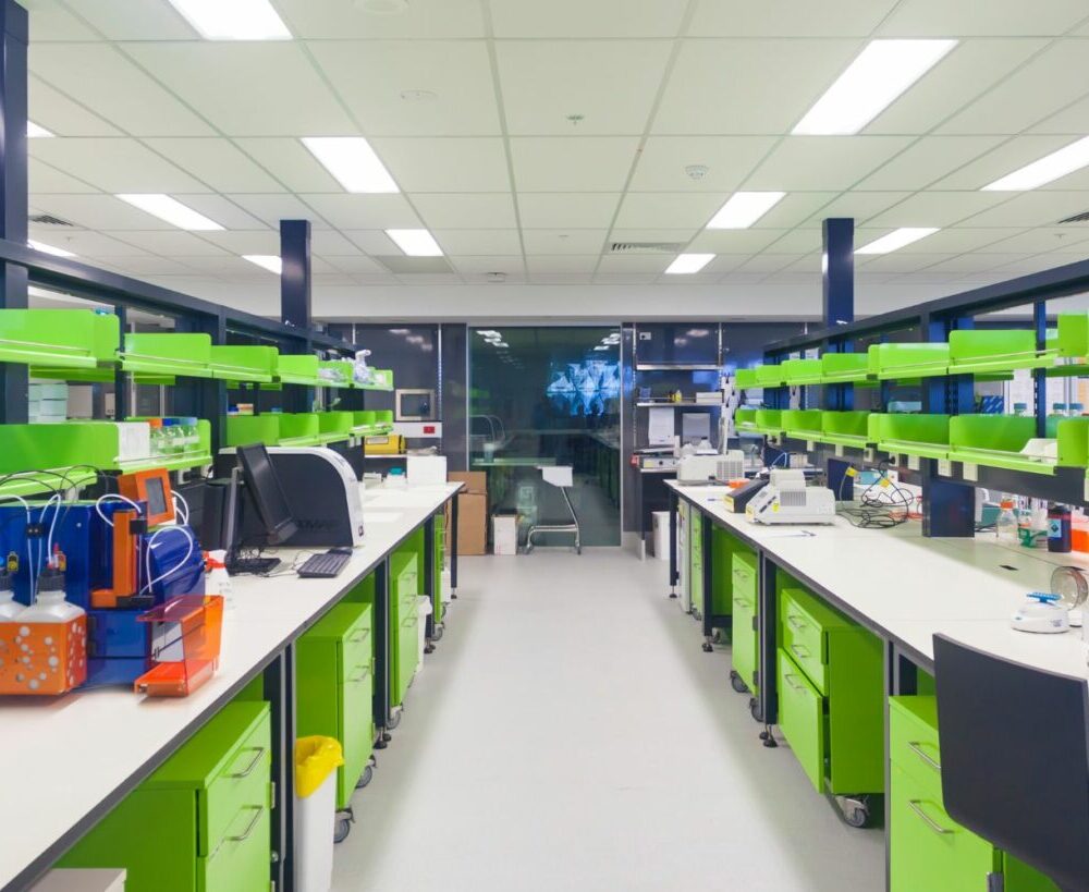 a room with green and white shelves and lab benches