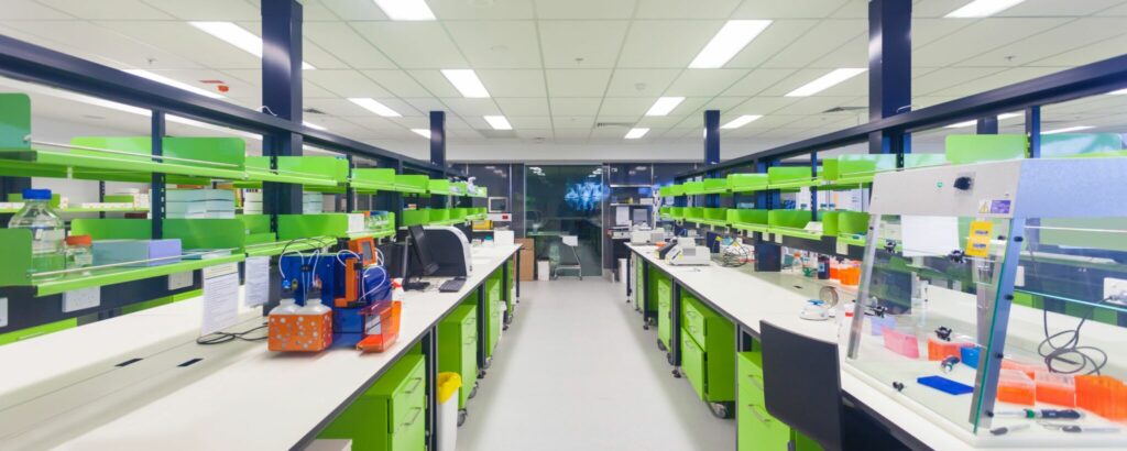 a room with green and white shelves and lab benches